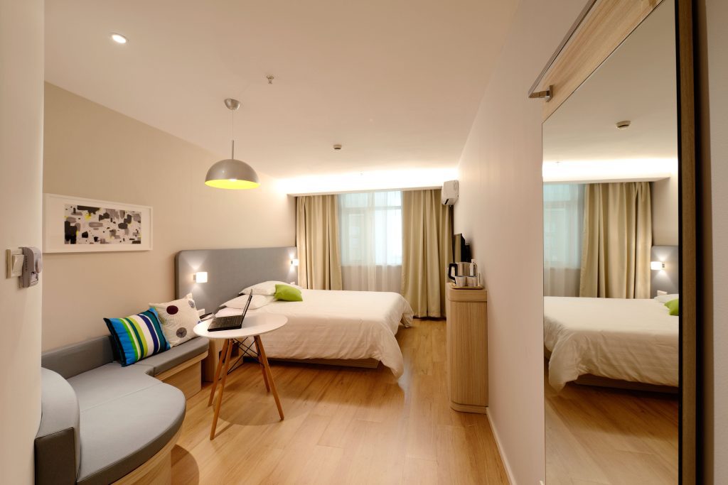 LVT flooring in a hotel room with soft seating and coffee table